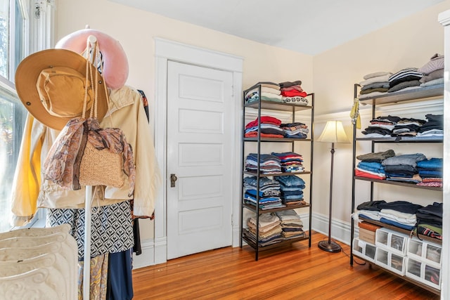 walk in closet with hardwood / wood-style floors