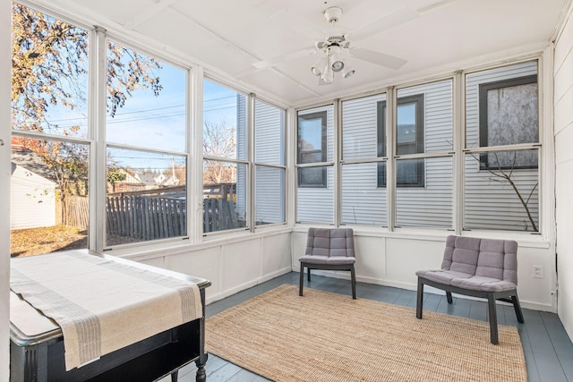 sunroom / solarium featuring ceiling fan