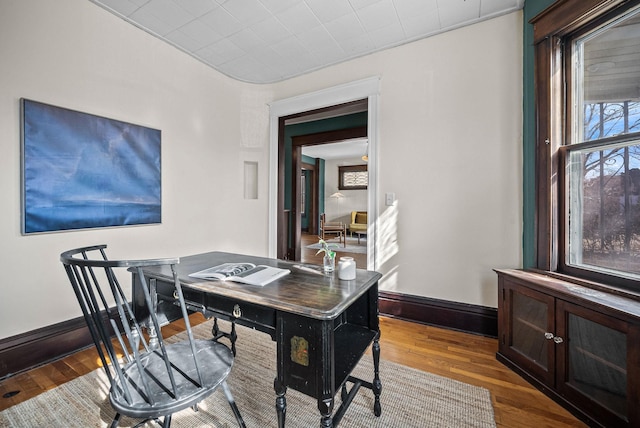 office area with wood finished floors and baseboards