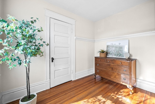 foyer entrance with baseboards and wood finished floors