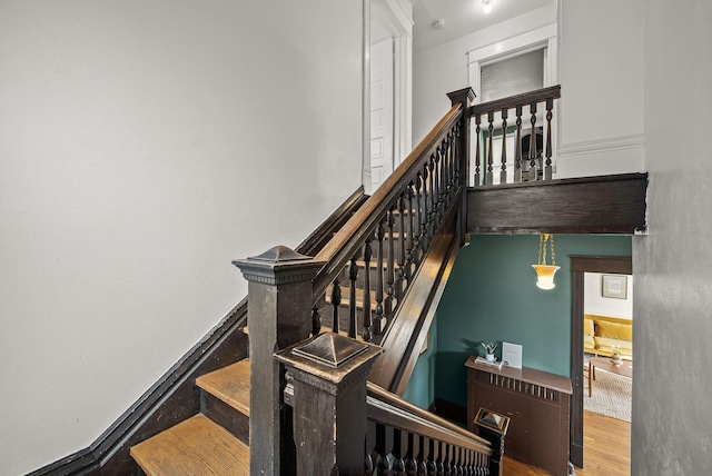 stairway featuring wood finished floors