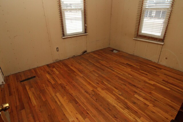 empty room with hardwood / wood-style flooring