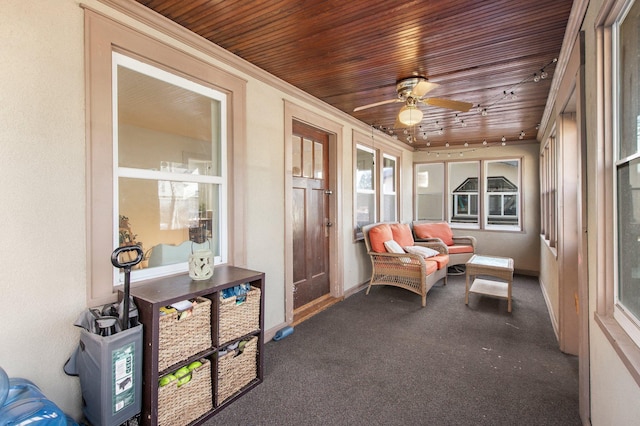 sunroom / solarium featuring wood ceiling and ceiling fan