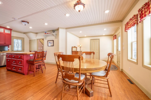 dining room featuring crown molding, wood ceiling, and light wood-type flooring