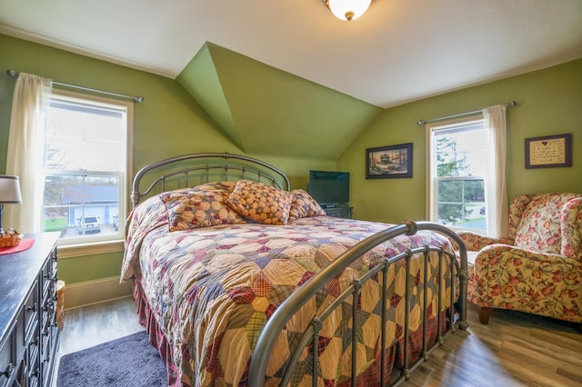 bedroom featuring dark hardwood / wood-style floors and vaulted ceiling