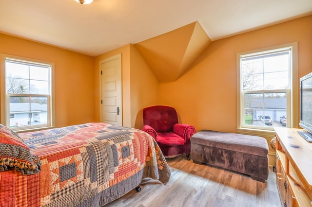 bedroom with light hardwood / wood-style flooring and multiple windows