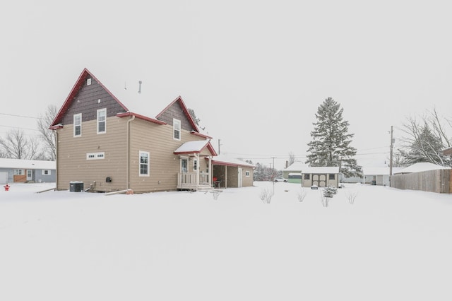 snow covered property featuring cooling unit