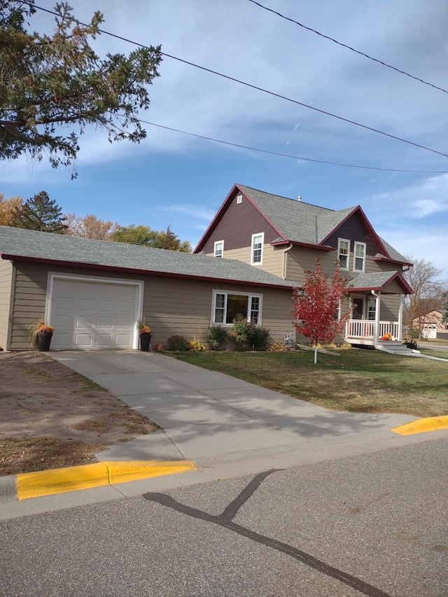 view of front of property with a front yard and a garage