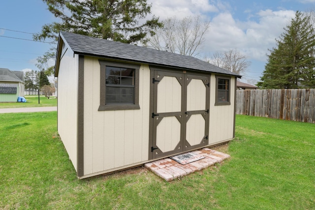 view of shed with fence