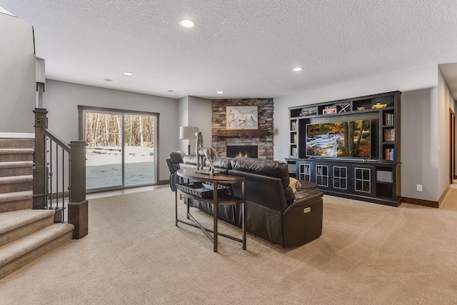 living room featuring a textured ceiling, light colored carpet, and a fireplace