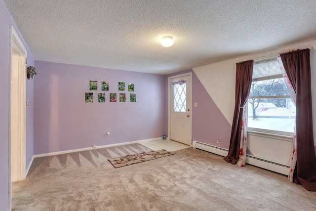 carpeted entrance foyer with a textured ceiling and baseboard heating