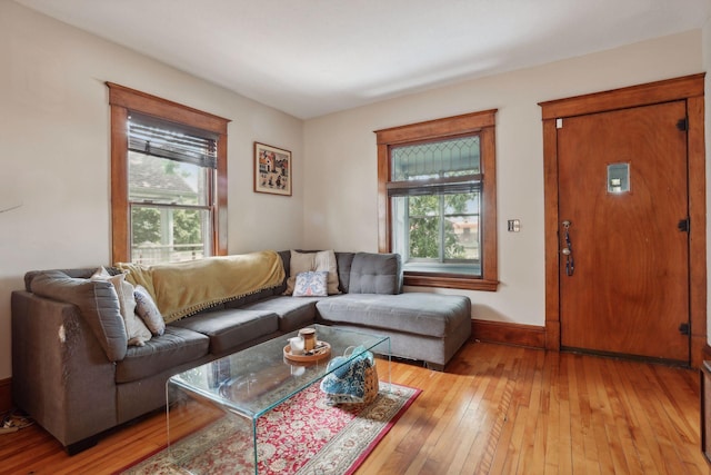 2724 Longfellow Ave, Minneapolis, MN 55407 - living area with plenty of natural light, hardwood / wood-style floors, and baseboards