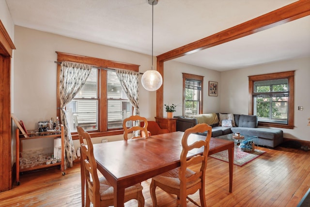 2724 Longfellow Ave, Minneapolis, MN 55407 - dining space featuring light wood-type flooring and beam ceiling