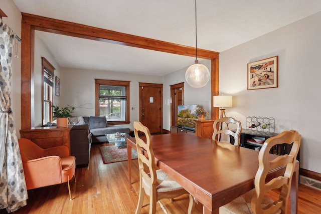 2724 Longfellow Ave, Minneapolis, MN 55407 - dining area with light wood finished floors and beamed ceiling