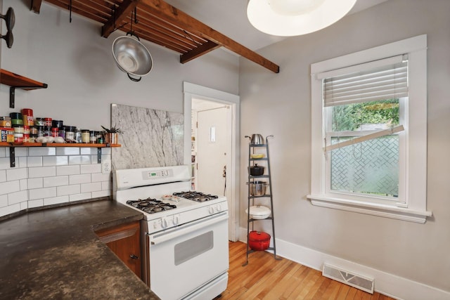 2724 Longfellow Ave, Minneapolis, MN 55407 - kitchen featuring white gas stove, open shelves, tasteful backsplash, and light wood-style floors