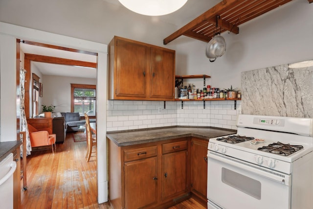 2724 Longfellow Ave, Minneapolis, MN 55407 - kitchen with white appliances, decorative backsplash, beam ceiling, dark countertops, and light wood-style flooring