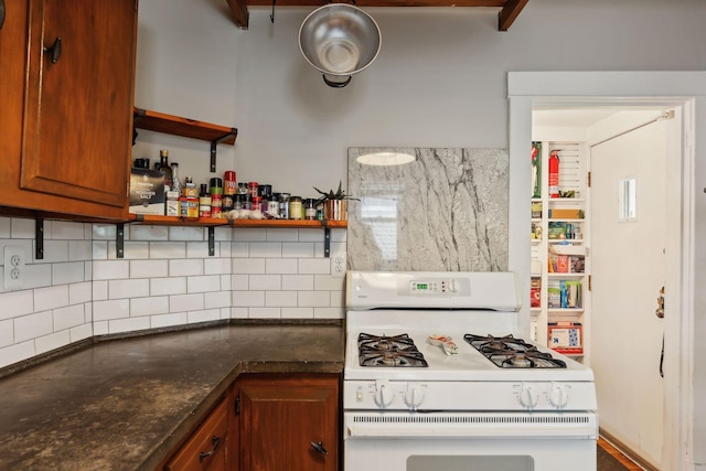 2724 Longfellow Ave, Minneapolis, MN 55407 - kitchen with white gas stove, decorative backsplash, brown cabinetry, and open shelves