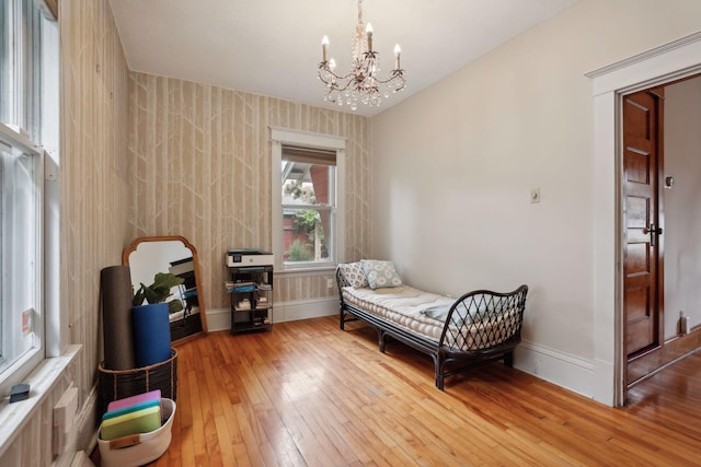 2724 Longfellow Ave, Minneapolis, MN 55407 - bedroom with wood-type flooring, a chandelier, and baseboards