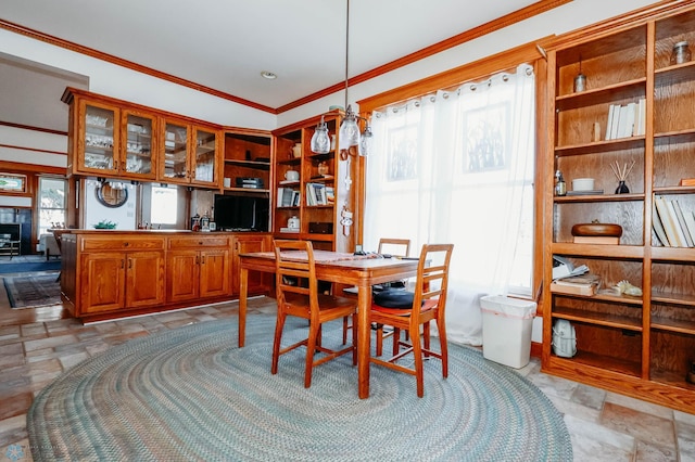 dining space featuring plenty of natural light and ornamental molding