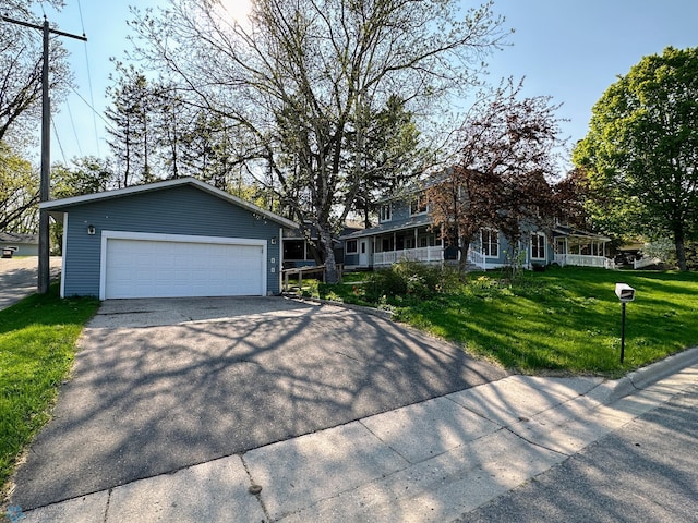 view of front of property with a garage and a front lawn