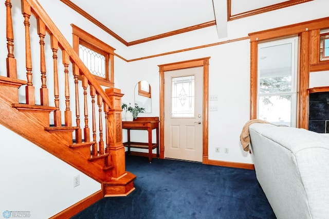 foyer with dark carpet and ornamental molding