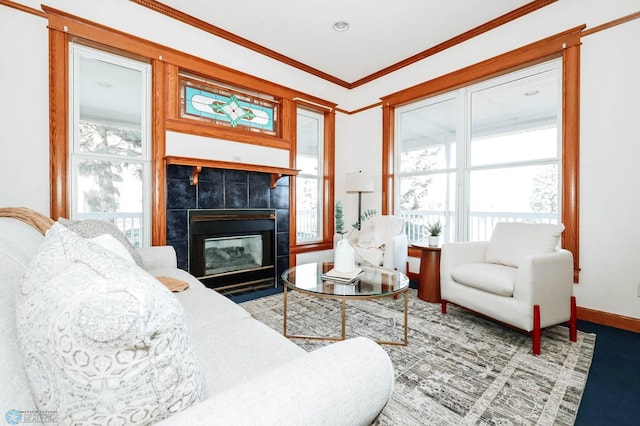 living room with crown molding and a tile fireplace