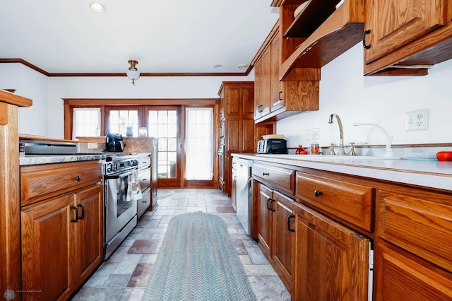 kitchen with appliances with stainless steel finishes, ornamental molding, and sink