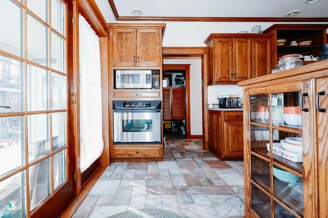 kitchen with appliances with stainless steel finishes, french doors, and ornamental molding