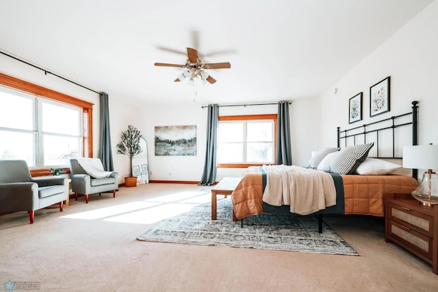 bedroom with carpet flooring, multiple windows, and ceiling fan