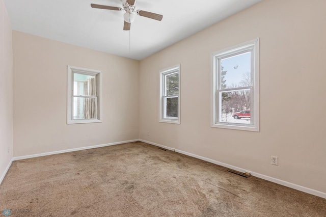 empty room with carpet flooring and ceiling fan