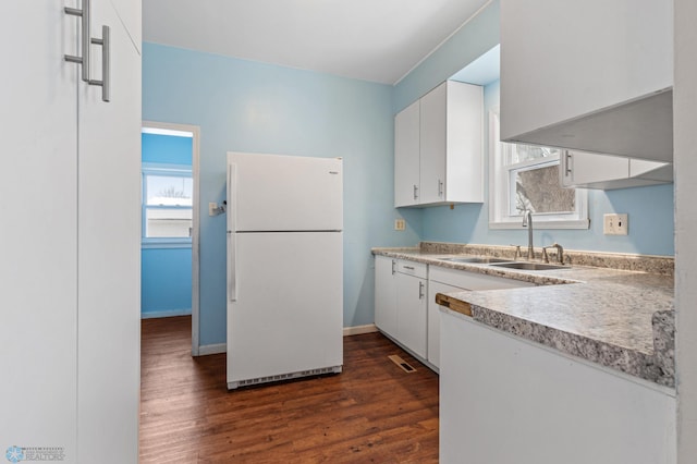 kitchen with white refrigerator, dark hardwood / wood-style floors, white cabinetry, and sink