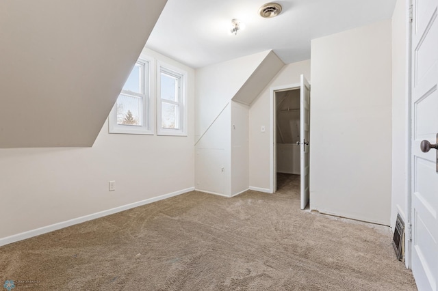 additional living space with light carpet and lofted ceiling