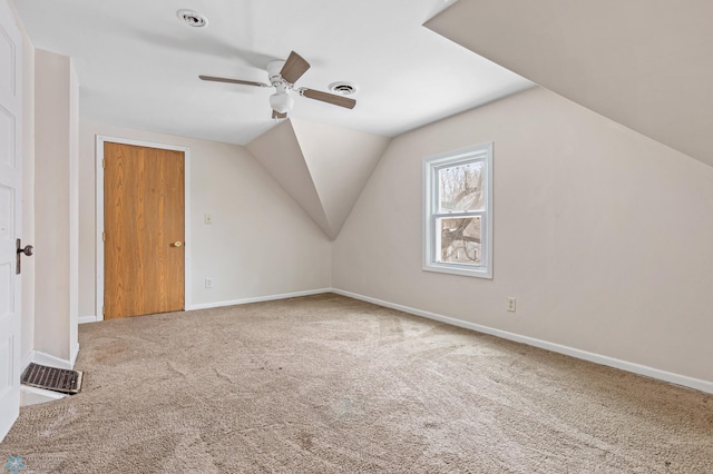 additional living space with carpet flooring, ceiling fan, and lofted ceiling