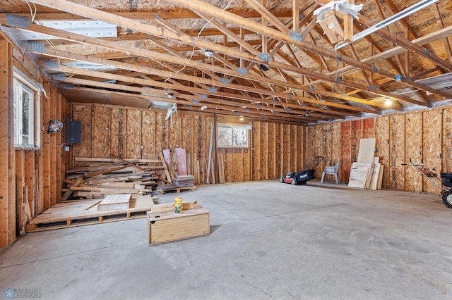 miscellaneous room featuring concrete floors and electric panel