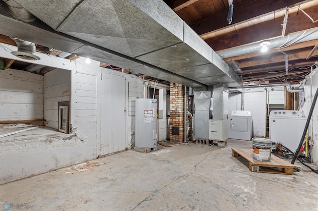 basement featuring heating unit, separate washer and dryer, and water heater