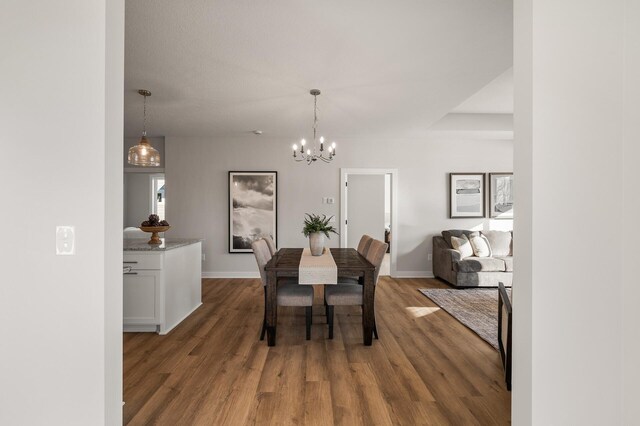 dining space featuring a chandelier and dark hardwood / wood-style flooring