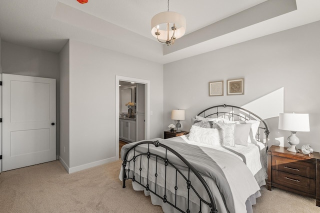 bedroom with light colored carpet and a raised ceiling