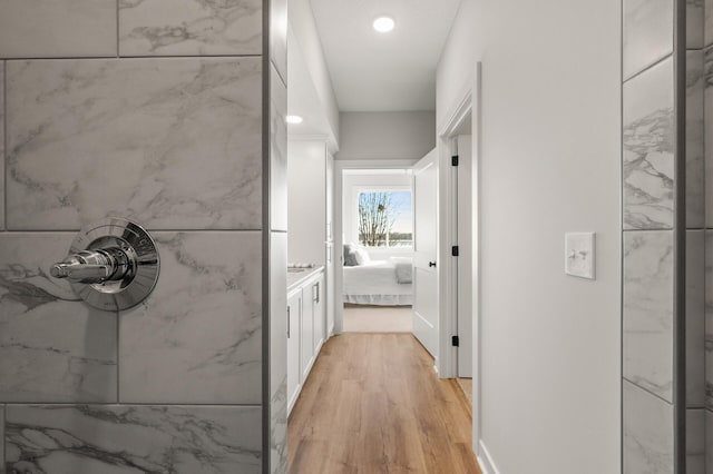 hallway with light hardwood / wood-style floors