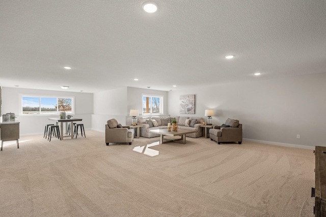 carpeted living room featuring a textured ceiling