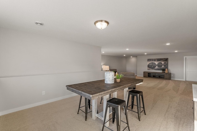 dining area featuring light carpet