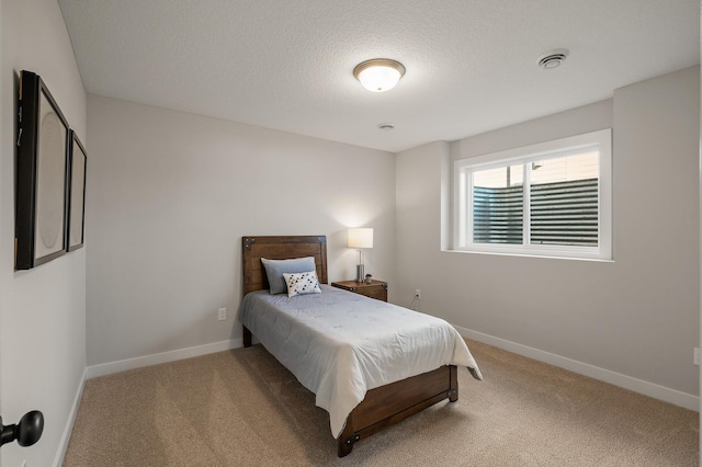 carpeted bedroom with a textured ceiling