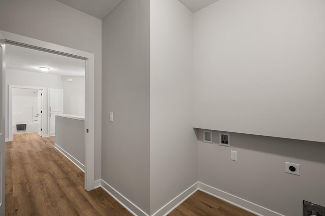 clothes washing area with hardwood / wood-style flooring, electric dryer hookup, a textured ceiling, and hookup for a washing machine