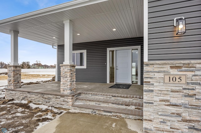 view of exterior entry featuring a porch