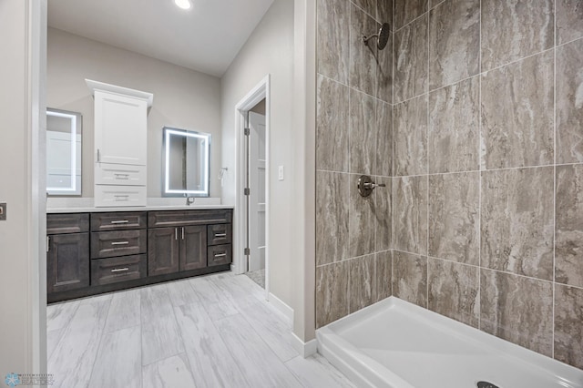 bathroom featuring vanity and tiled shower