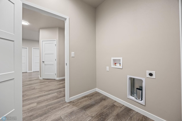 clothes washing area featuring washer hookup, electric dryer hookup, and light wood-type flooring