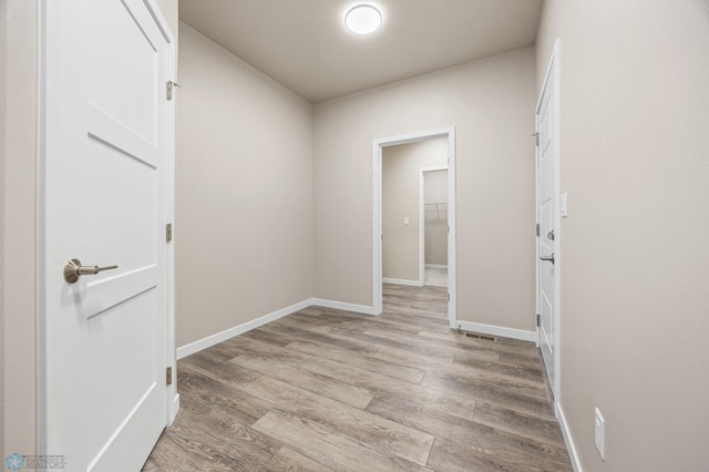 corridor featuring light hardwood / wood-style floors