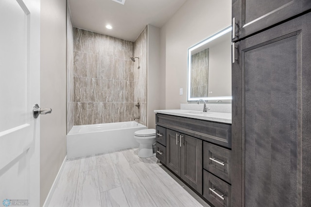 full bathroom featuring vanity, toilet, and tiled shower / bath