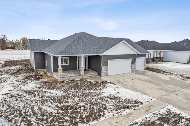 view of front of house featuring covered porch and a garage