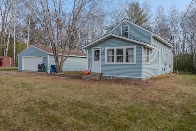 view of front of house featuring a front lawn, an outdoor structure, and a garage