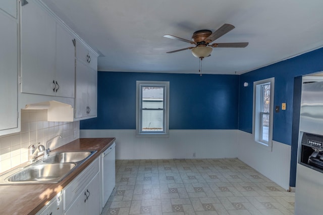 kitchen featuring white cabinets, stainless steel fridge with ice dispenser, dishwasher, and sink